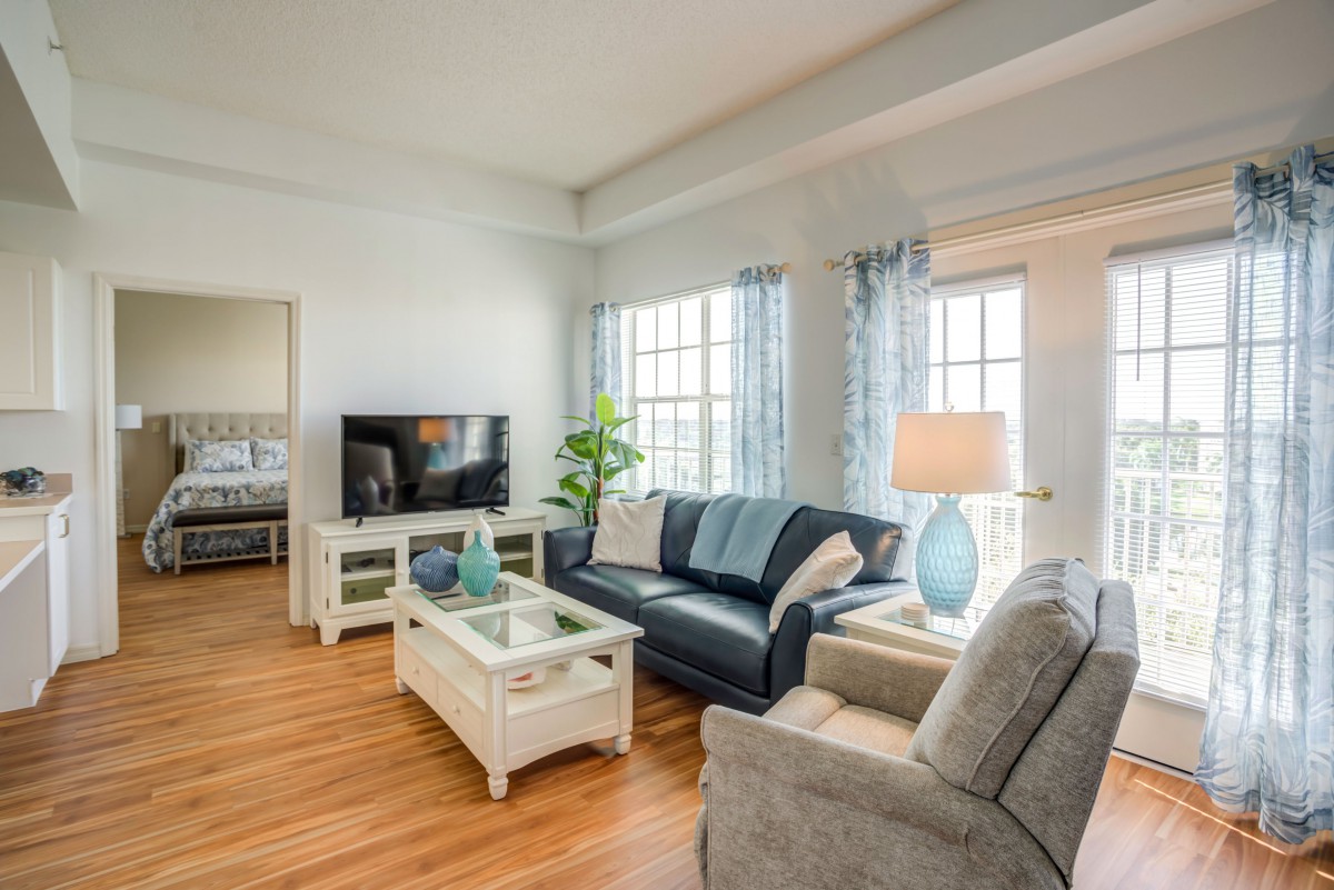A cozy living room with a sofa, TV, and stylish decor.