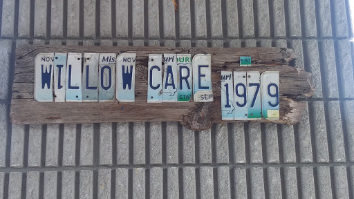Creative wall art made from vintage license plates spelling 'LOW CARE' with the year '1979'.
