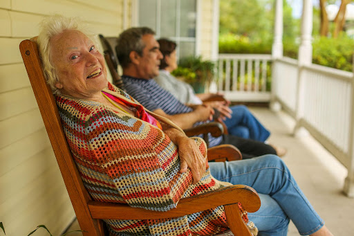 A joyful moment on the porch, where generations come together to enjoy the simple pleasures of life.
