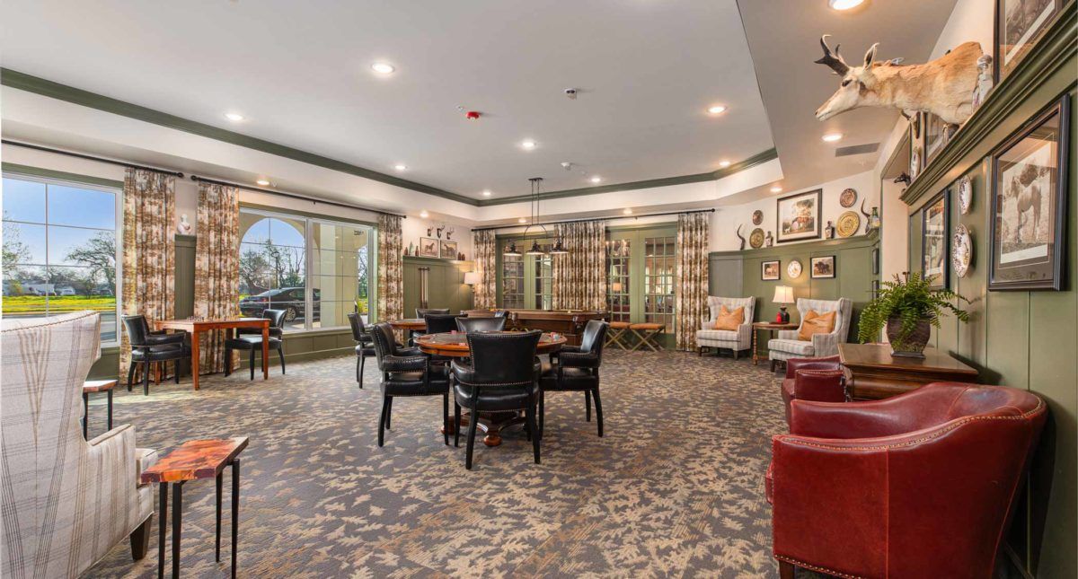 A spacious and elegantly decorated lounge with multiple seating areas and ambient lighting.