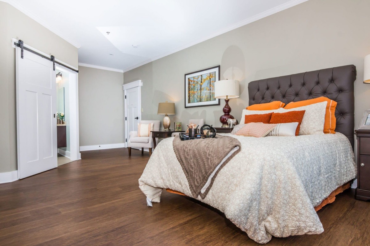 A modern and cozy bedroom with stylish furnishings and warm tones.