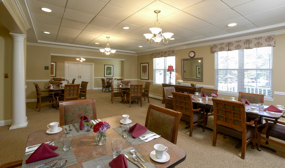 A well-decorated dining room with neatly arranged tables and chairs.