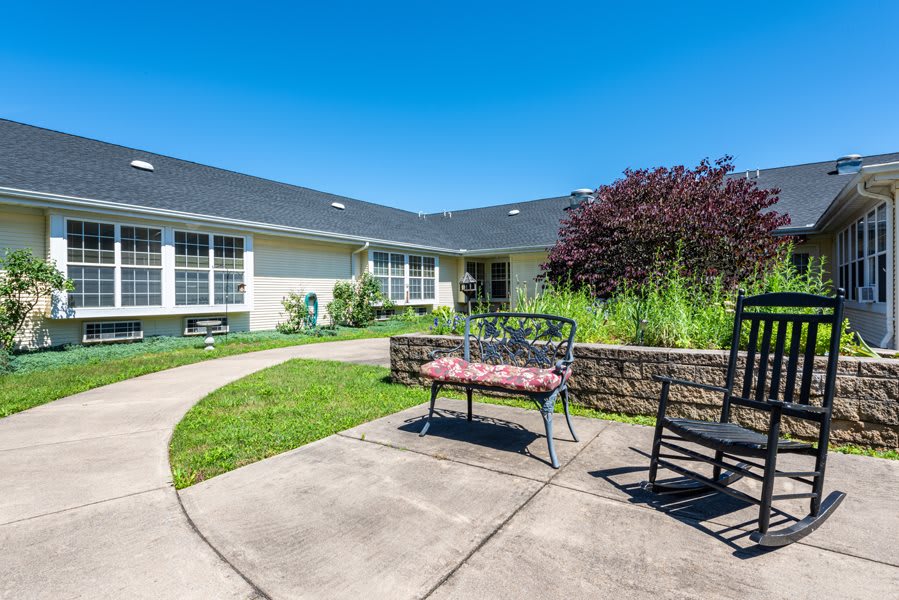 A sunny courtyard with benches and landscaped garden.