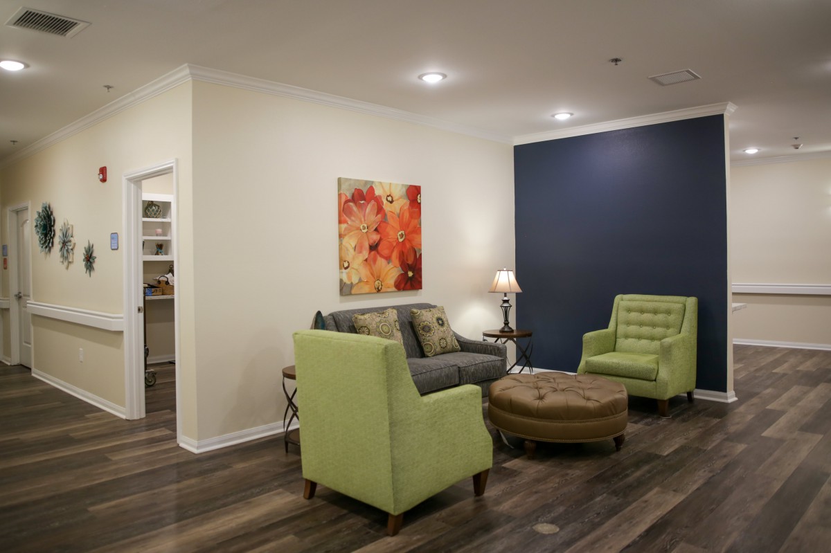 A cozy living room with contemporary furniture and warm lighting.