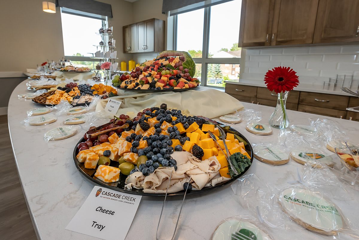 A beautifully arranged buffet table featuring a cheese and fruit platter, perfect for a party or catered event.