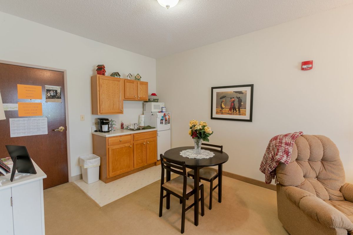 A cozy living space with a small kitchenette and dining area.