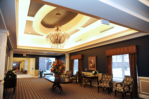 An elegantly designed lobby featuring a beautiful chandelier, luxurious seating, and tasteful decor.