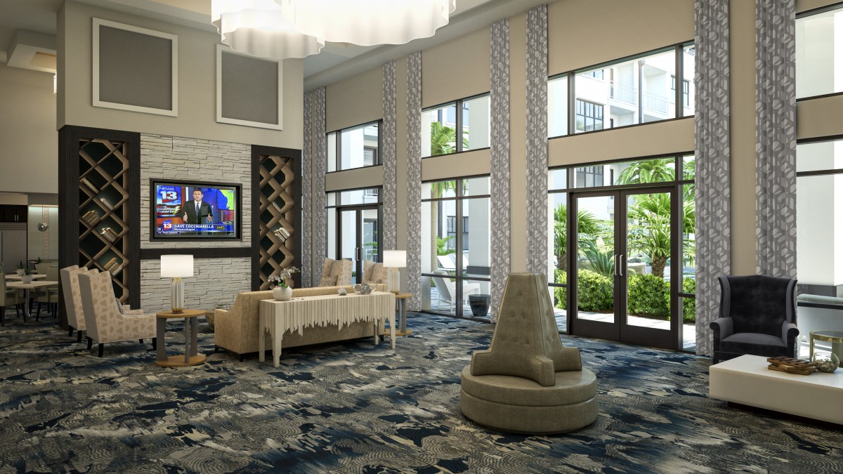 Modern lobby area with stylish furniture and large windows offering a view outside.