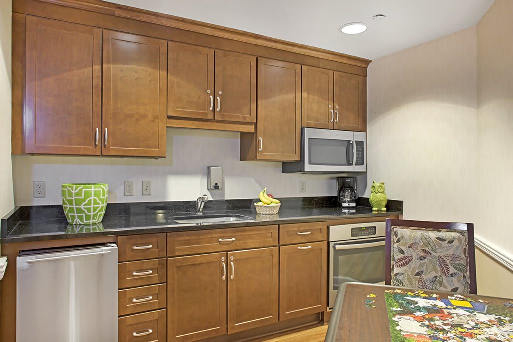A modern kitchen with wooden cabinets and a sleek countertop.
