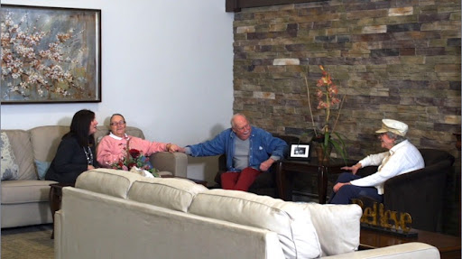 A serene moment in a living room where people are engaged in conversation.