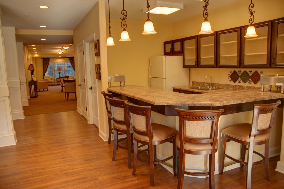 A cozy kitchen with bar seating and pendant lights.
