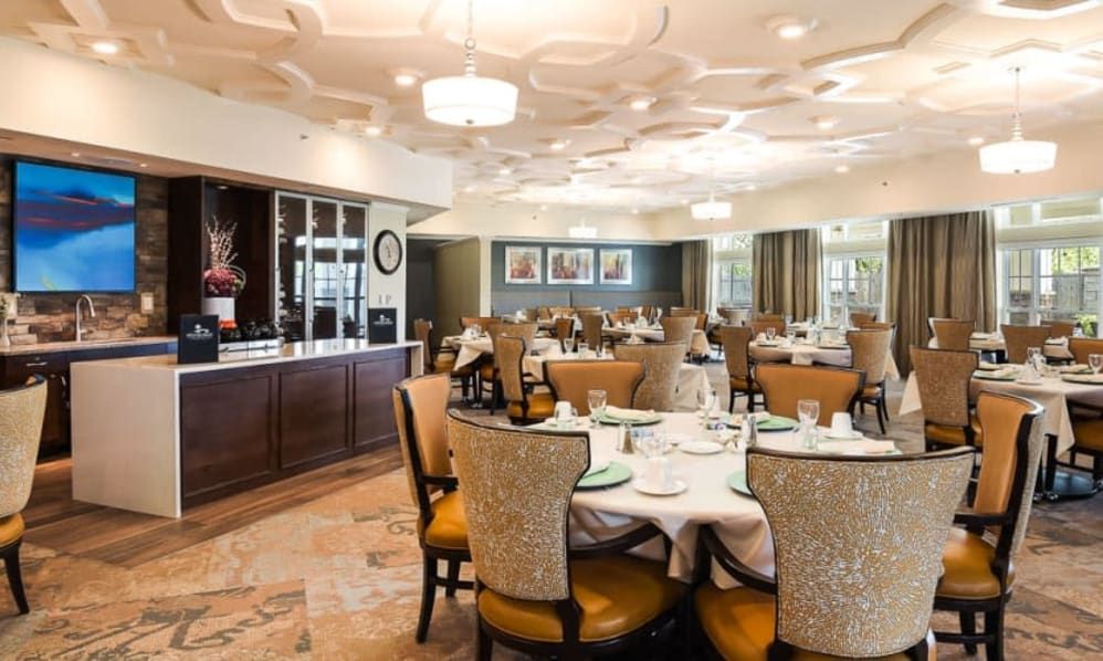 An elegant dining room with neatly arranged tables and chairs, ready for guests.