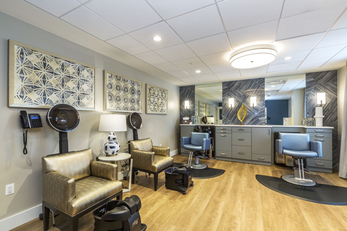 A modern salon interior with hair drying stations and stylish decor.