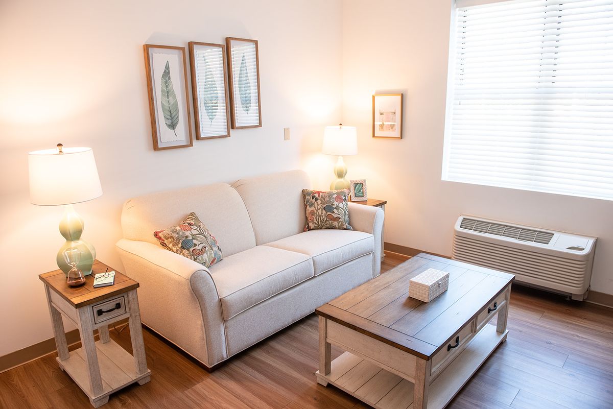 A cozy living room with a comfortable sofa, decorated with wall art and a stylish coffee table.