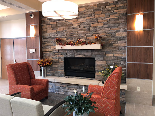 A cozy living room featuring a stone fireplace and modern furnishings, perfect for relaxation.