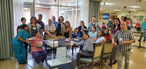 A joyful gathering of friends sharing a meal together in a warm, inviting space.