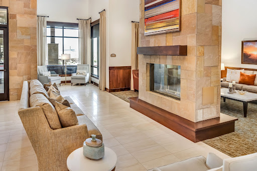 A modern living room featuring a stylish fireplace, contemporary artwork, and comfortable seating.