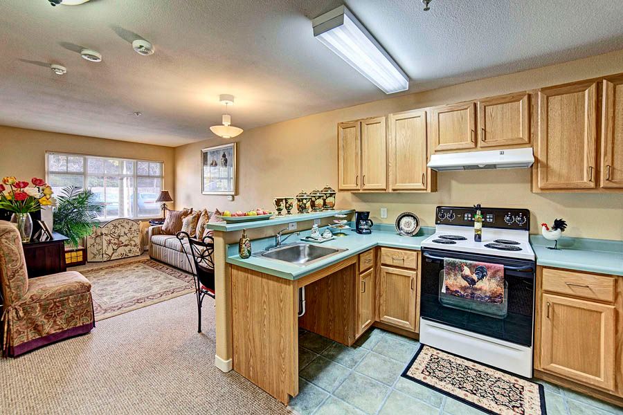 A cozy apartment with an open kitchen leading into a comfortable living room area.