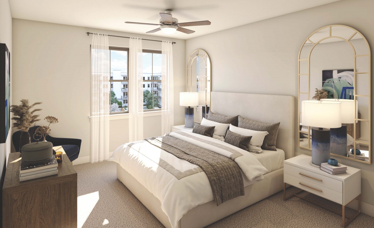 A modern bedroom with neutral decor and natural light.