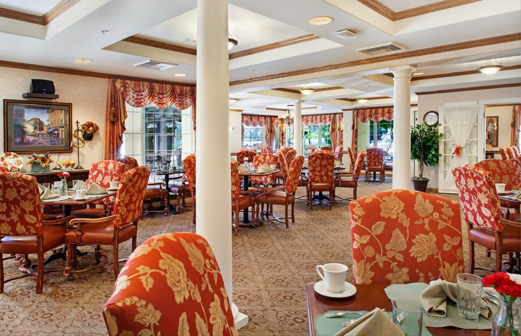 Elegant dining area with patterned chairs and neatly arranged tables.