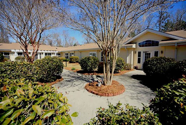 A beautiful house surrounded by well-maintained landscaping and a pathway.
