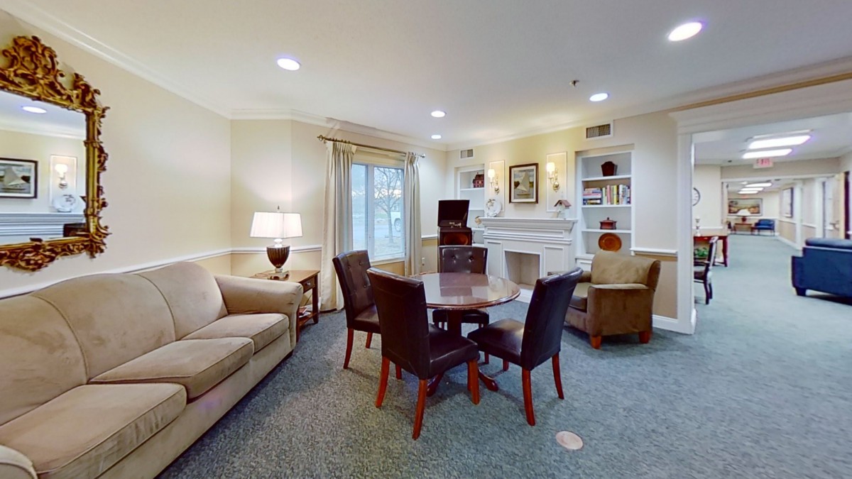 Cozy living room with a round table and chairs, sofa, and decorative elements.