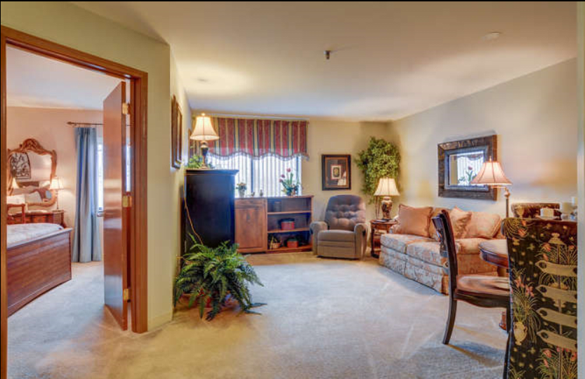 A cozy living room with comfortable seating and warm lighting.