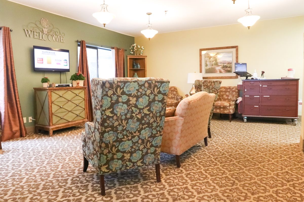 A cozy living room with comfortable chairs and a television.