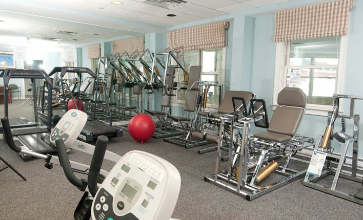 A well-equipped gym with various exercise machines and equipment.