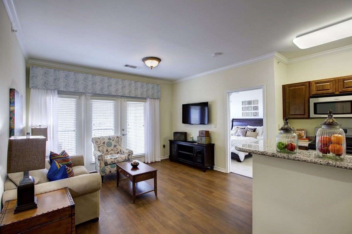 A cozy living room with modern furnishings and a hardwood floor.