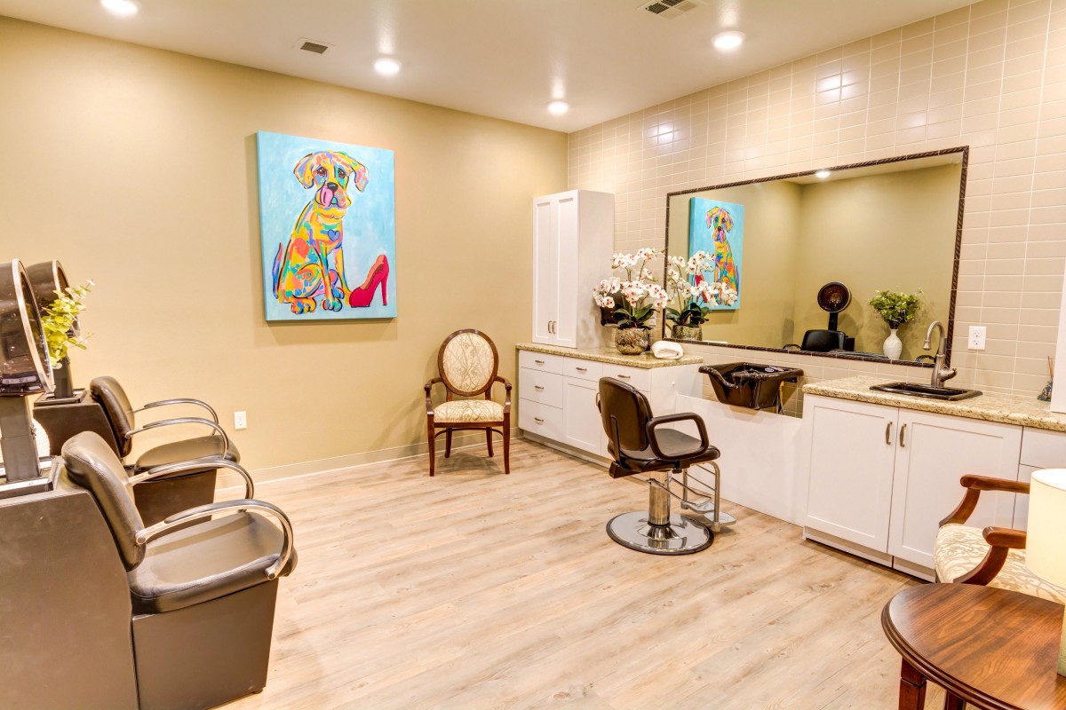A modern salon interior with stylish decor and colorful artwork.