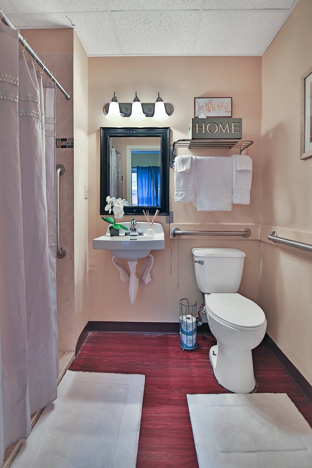 A modern bathroom with a sink, toilet, and shower.