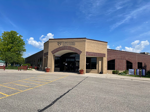 A modern commercial building with a welcoming entrance on a sunny day.