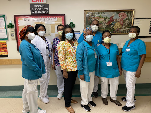 A dedicated healthcare team posing together in a hospital setting.
