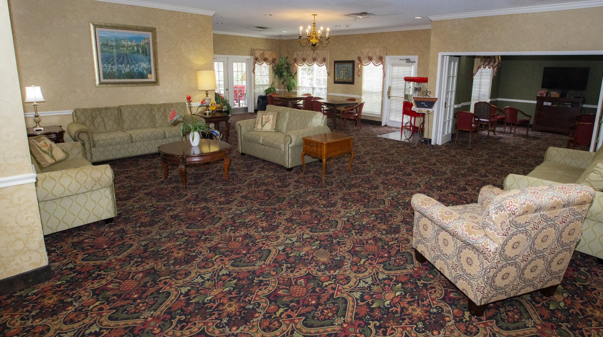 Cozy living room with traditional furniture and patterned carpet.