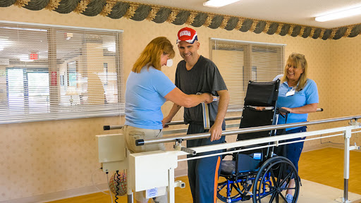 A therapist assists a patient during a rehabilitation session in a healthcare facility.