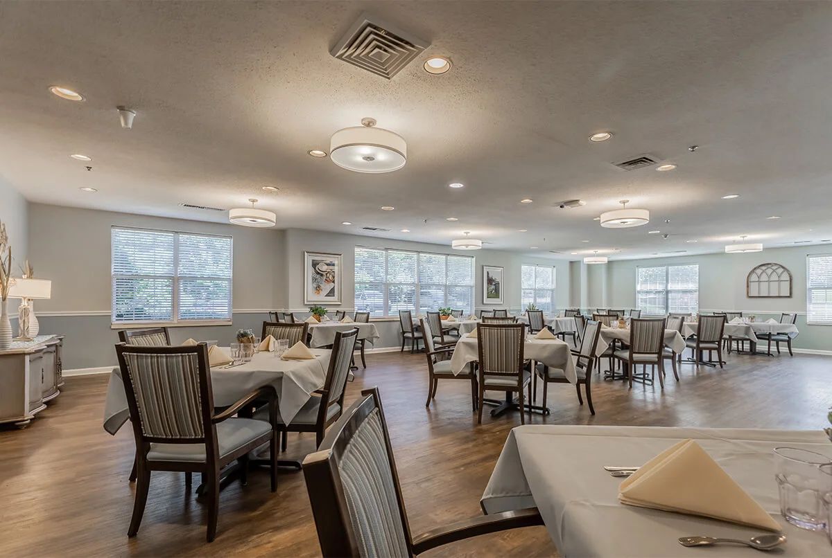 An elegantly furnished dining area with neatly arranged tables and chairs.
