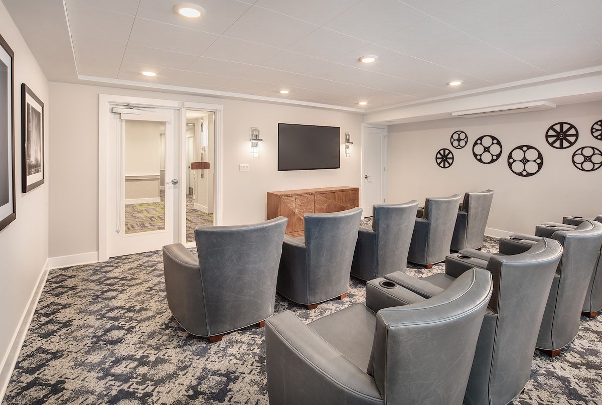 A modern home theater with comfortable seating and a large screen.