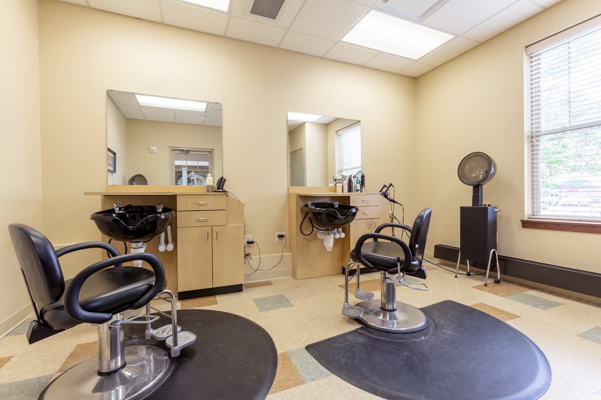 A neat and modern hair salon interior with styling chairs and mirrors.