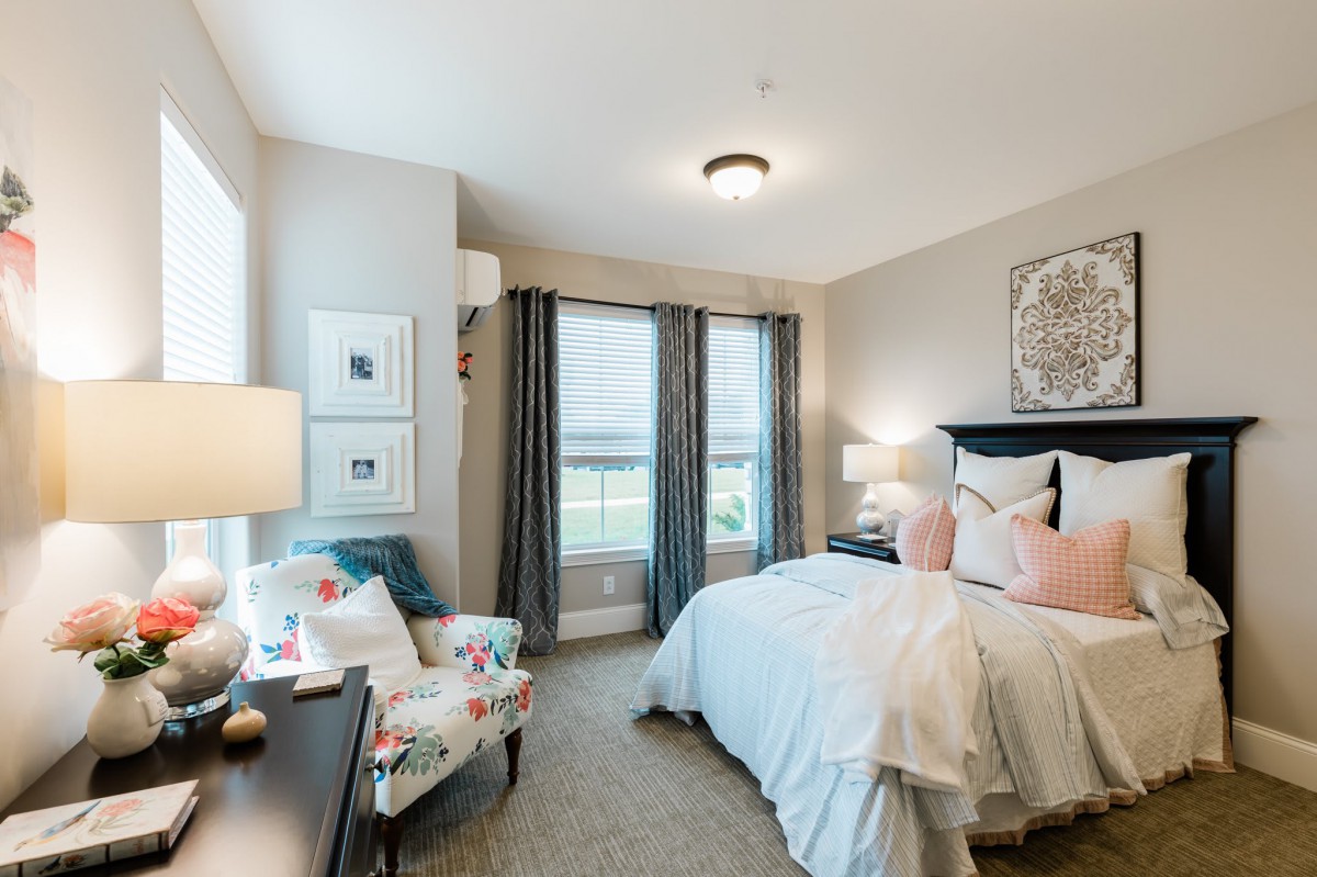 A cozy bedroom with stylish decor and ample natural light.