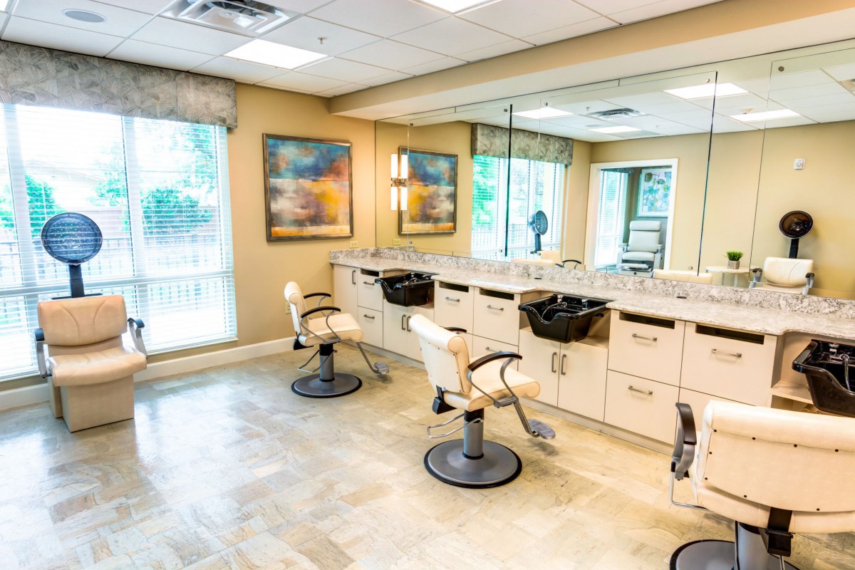 A modern hair salon with comfortable chairs and bright, spacious interiors.