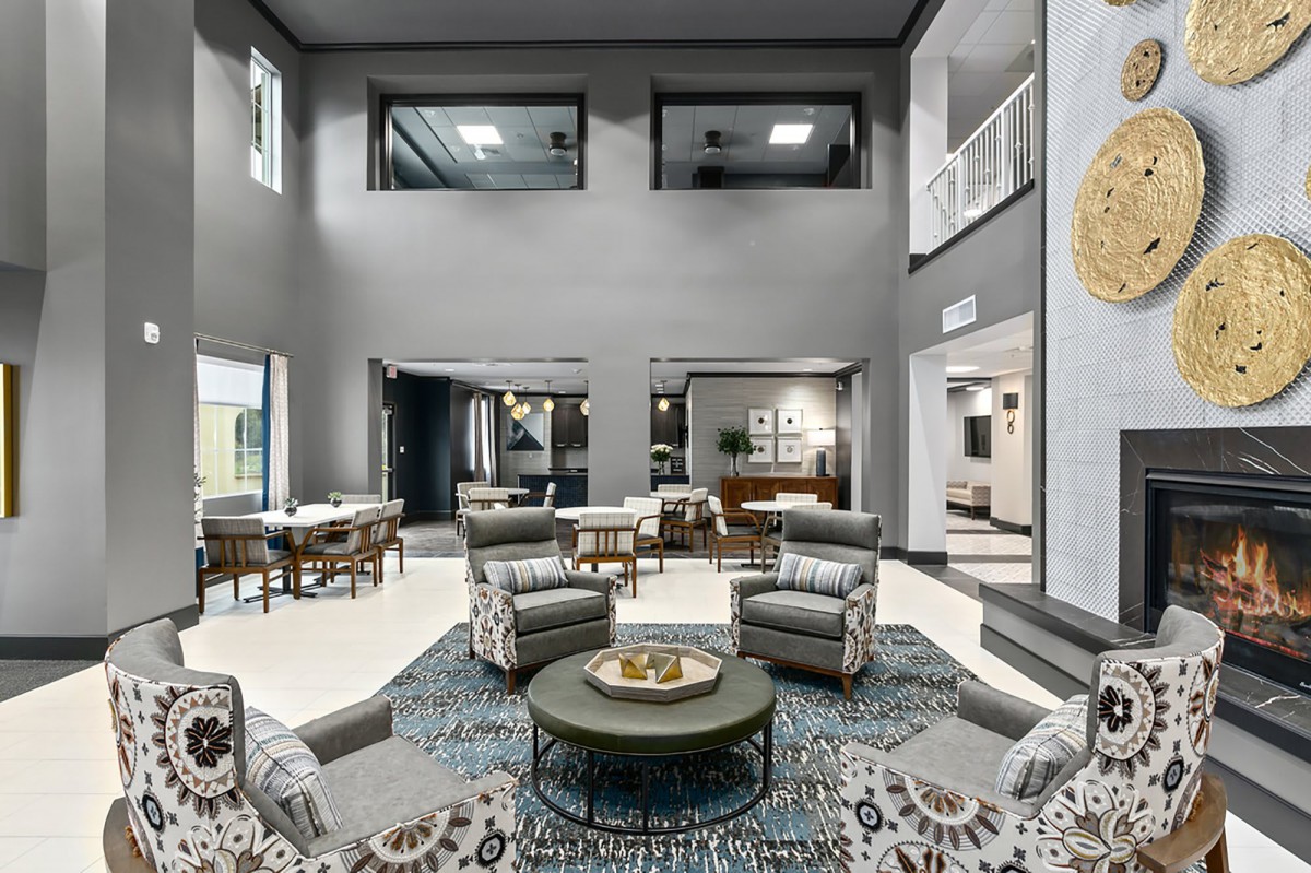 A modern and luxurious lobby featuring a seating area with stylish furniture and elegant decor.