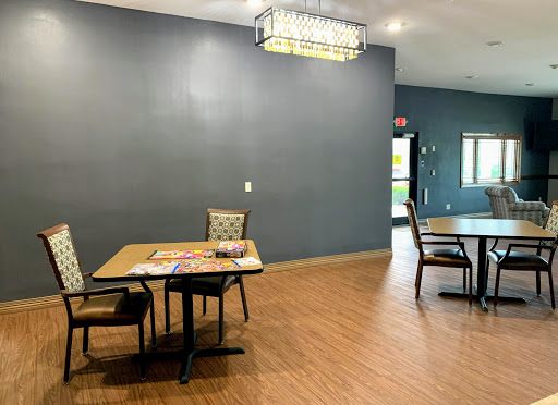 A spacious and modern dining area featuring tables and chairs with decorative lighting.