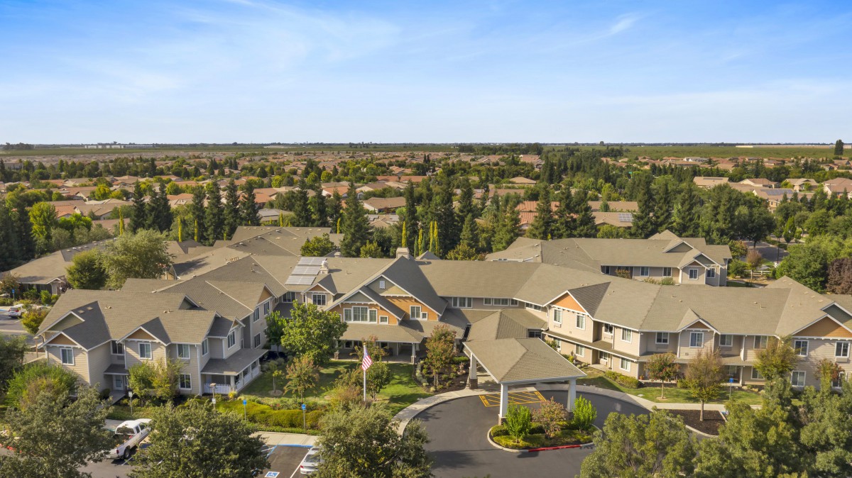 Aerial view of a suburban residential neighborhood surrounded by trees.