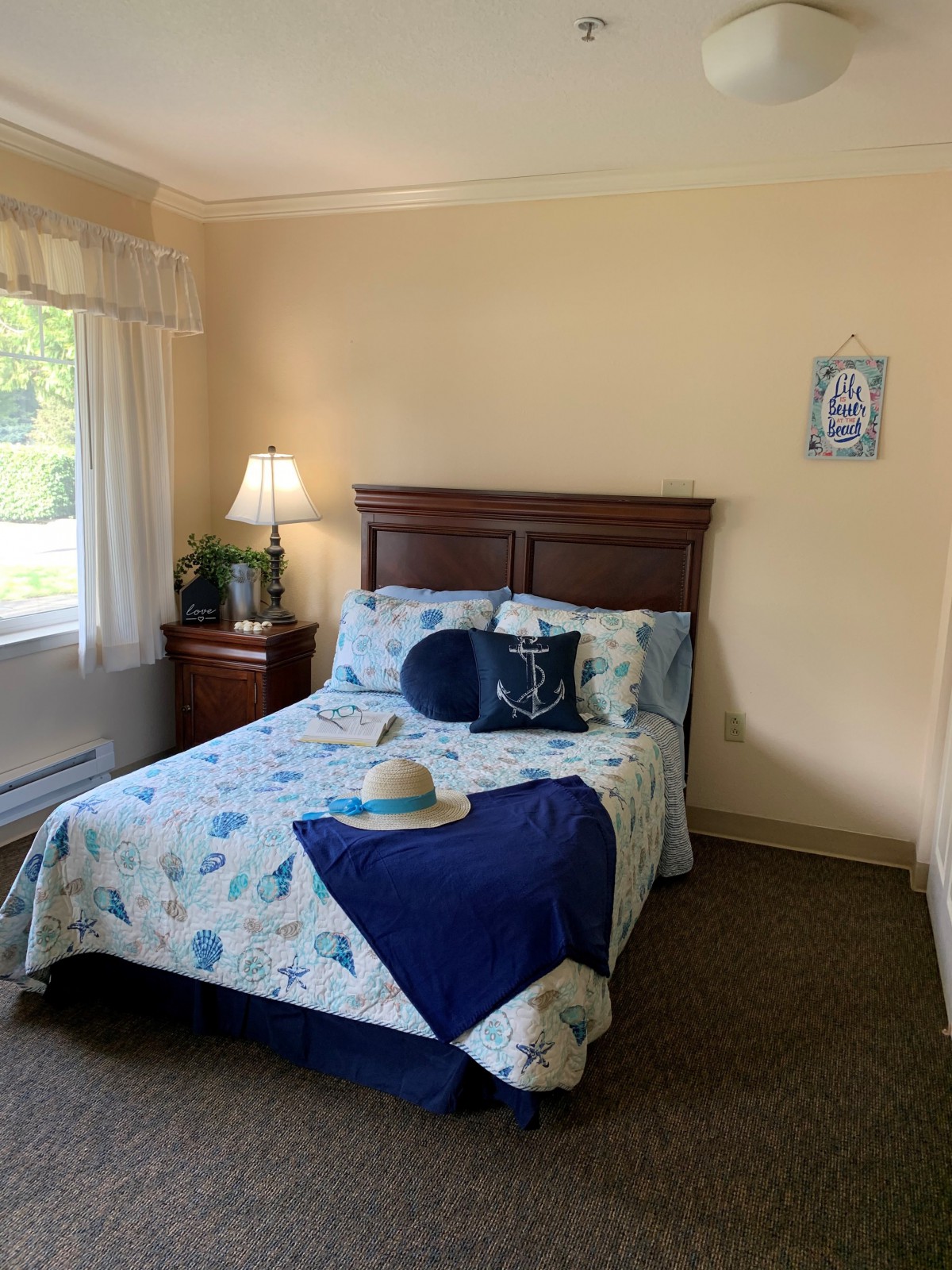 A cozy bedroom with a neatly made bed, decorative pillows, and soft lighting.