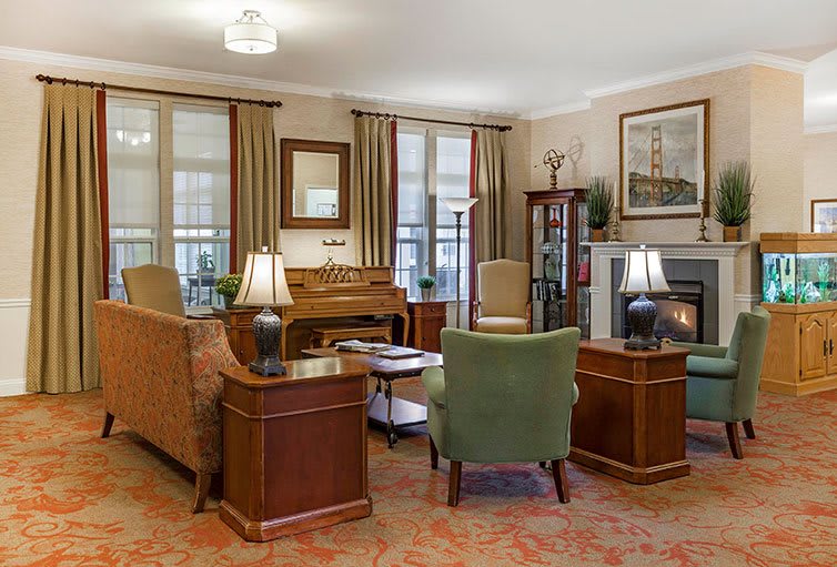 A cozy living room with elegant furniture and a warm fireplace.