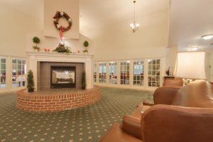 A cozy living room with a decorated fireplace and comfortable seating.