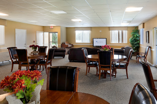 A spacious lounge area featuring comfortable seating and dining tables, perfect for community gatherings.