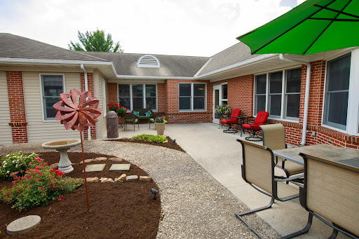 A cozy courtyard featuring a blend of seating arrangements and colorful landscaping.