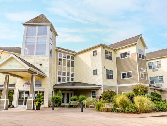 A modern hotel with a sleek exterior and well-maintained landscaping.
